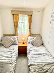 two beds in a small room with a window at "The Snug" in Knaresborough