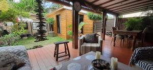 a patio with a table and chairs on a deck at Appartement de charme à côté de la plage in La Saline les Bains