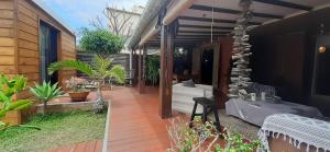 a patio of a house with plants on it at Appartement de charme à côté de la plage in La Saline les Bains