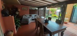 a dining room with a wooden table and chairs at Appartement de charme à côté de la plage in La Saline les Bains +17 photos