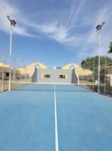 a tennis court with two lights on top of it at Hotel Pórtico Norte in Tartagal