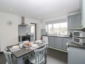 a kitchen with a table and some chairs in it at Pool House in Monmouth