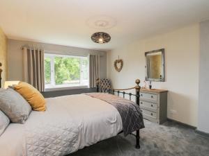 a bedroom with a bed and a mirror and a dresser at Pool House in Monmouth