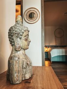 a statue sitting on top of a wooden table at CARI APARTMENTS, Hillside in Dolný Kubín