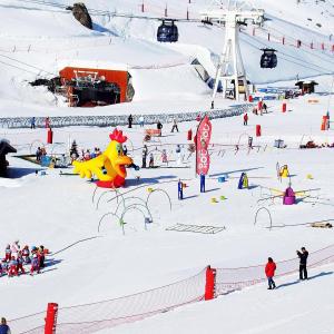 a group of people in the snow on a ski slope at Cosy Val Tho ski aux pieds in Val Thorens