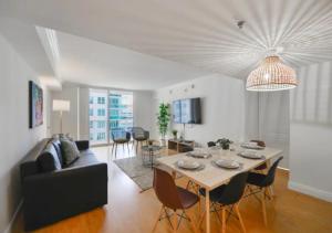 a living room with a table and a couch at 2BD Condo At Brickell With Bay View in Miami