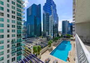 a view of a pool in a city with tall buildings at 2BD Condo At Brickell With Bay View in Miami