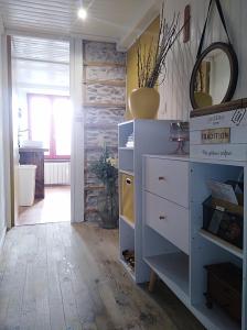 a room with a white dresser with a mirror on the wall at Appartement cozy maison Ed Den in Tauves