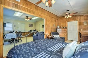 a bedroom with a bed and a dining room at Cozy Hawkinsville Studio on Operating Farm! in Hawkinsville