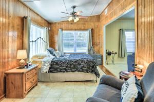 a bedroom with a bed and a couch at Cozy Hawkinsville Studio on Operating Farm! in Hawkinsville
