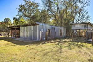 a large metal building in a yard with a shed at Cozy Hawkinsville Studio on Operating Farm! in Hawkinsville