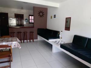 a living room with couches and a table and chairs at Uma PAUSA na sua vida, com: sol, praia e sossego! in Cabo Frio