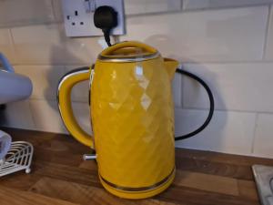 a yellow jug sitting on top of a table at TimeChance Property Homz - Norton Road 1 Bed Apartment in Stockton-on-Tees