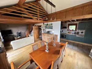 a kitchen and dining room with a wooden table and chairs at Gîte le mirador in Bouillon