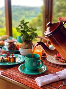 a table with a teapot and a cup of coffee at Reserva da Collina in Gramado