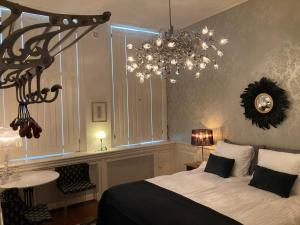 a bedroom with a large bed and a chandelier at GuesthouseOne in Haarlem