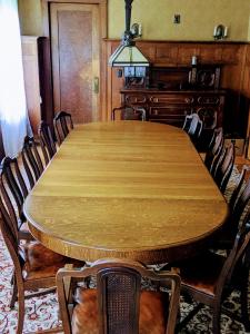a dining room with a wooden table and chairs at The Marshall House in Niagara Falls