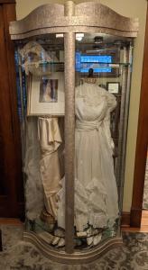 a display case with a dress and shoes in it at The Marshall House in Niagara Falls