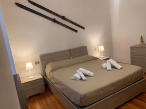 a bedroom with a bed with two pillows on it at CASA MASCIA in Cencenighe