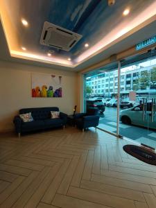 a living room with a couch and a view of a parking lot at CAPITAL EXPRESS in Kota Kinabalu
