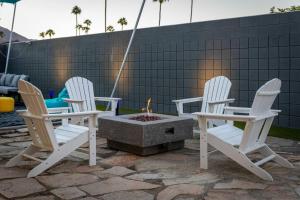 a group of chairs around a fire pit at The Desert Xscape Pool & Views in Palm Springs
