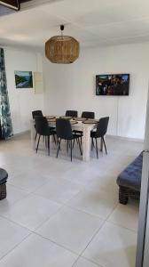 une salle à manger avec une table, des chaises et un lustre dans l'établissement Villa Creole alamanda 2, à Petite Île