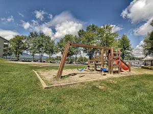 a playground with a slide in a park at Location Tourisme Estrie - Oberge du Village in Magog-Orford