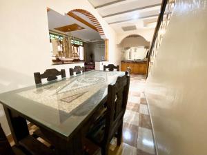 a kitchen with a table and chairs and a refrigerator at Fully equipped villa Near Agadir in Agadir