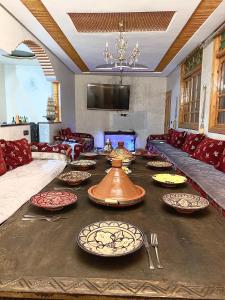 a living room with a table with plates on it at Fully equipped villa Near Agadir in Agadir