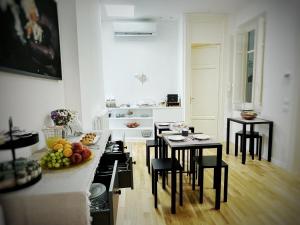 a kitchen with a counter and a table with fruits on it at Nostrale bnb in Palermo
