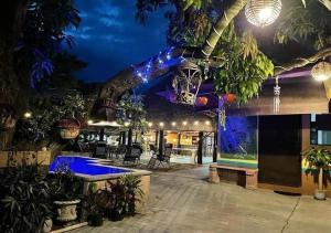 a resort with a tree growing out of a building at Hotel Casa Puerta Huasteca in Ciudad Valles