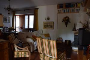 a living room with a couch and some chairs at Casa Rosa in Pescasseroli