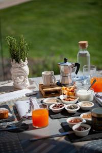 a table with food and a tea kettle on it at I Carusi Relais in Noto