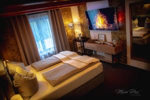 a bedroom with two beds and a desk and a window at Villa Prestige in Zeitz
