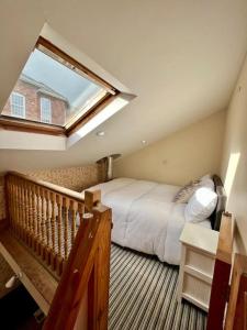a bedroom with a large bed and a window at Cosy 2 bed cottage on Dartmoor , Near Ivybridge in Plymouth