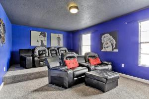 a living room with blue walls and leather chairs at Tropical Nights - 8 bed ChampionsGate Resort family pool home in Davenport +82 photos