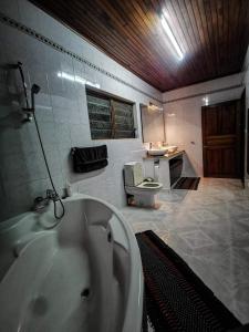 a bathroom with a tub and a toilet in it at L'anis Etoilé in Antsirabe