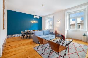 a living room with a couch and a table at WHome Alecrim 43 Top Location perfect to explore Lisbon in Lisbon