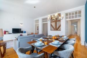 a dining room and living room with a table and chairs at WHome Alecrim 43 Top Location perfect to explore Lisbon in Lisbon