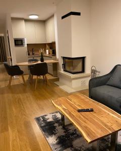 a living room with a couch and a table at MA Apartment Jahorina in Jahorina