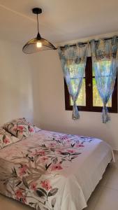 a bedroom with a bed and a window at Villa Creole alamanda 2 in Petite Île