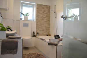 a bathroom with a tub and a toilet and a sink at 5 Sterne Apartment Auszeit in Wilhelmsfeld