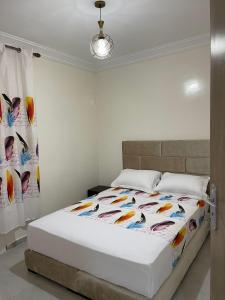 a bedroom with a bed with a colorful blanket at Appartement meublé proche de la mer à Agadir in Agadir