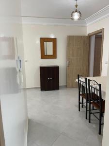 a room with a table and two chairs and a phone at Appartement meublé proche de la mer à Agadir in Agadir