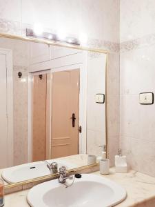 a bathroom with a sink and a mirror and a tub at Casa El Cornijal - Piscina Privada in San Javier