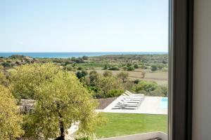 a view of a pool from a window at I Carusi Relais in Noto