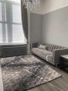 a living room with a couch and a rug at The Princess Flat, Helensburgh. in Helensburgh +6 photos