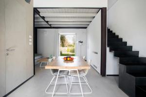 a dining room with a table and chairs and a staircase at I Carusi Relais in Noto