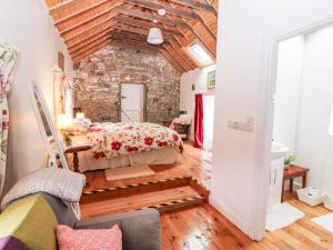 a bedroom with a bed and a brick wall at The Dairy in Clonmel