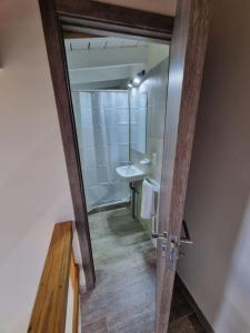 a bathroom with a toilet and a sink and a mirror at Lomas Schuss ARG41 in San Carlos de Bariloche